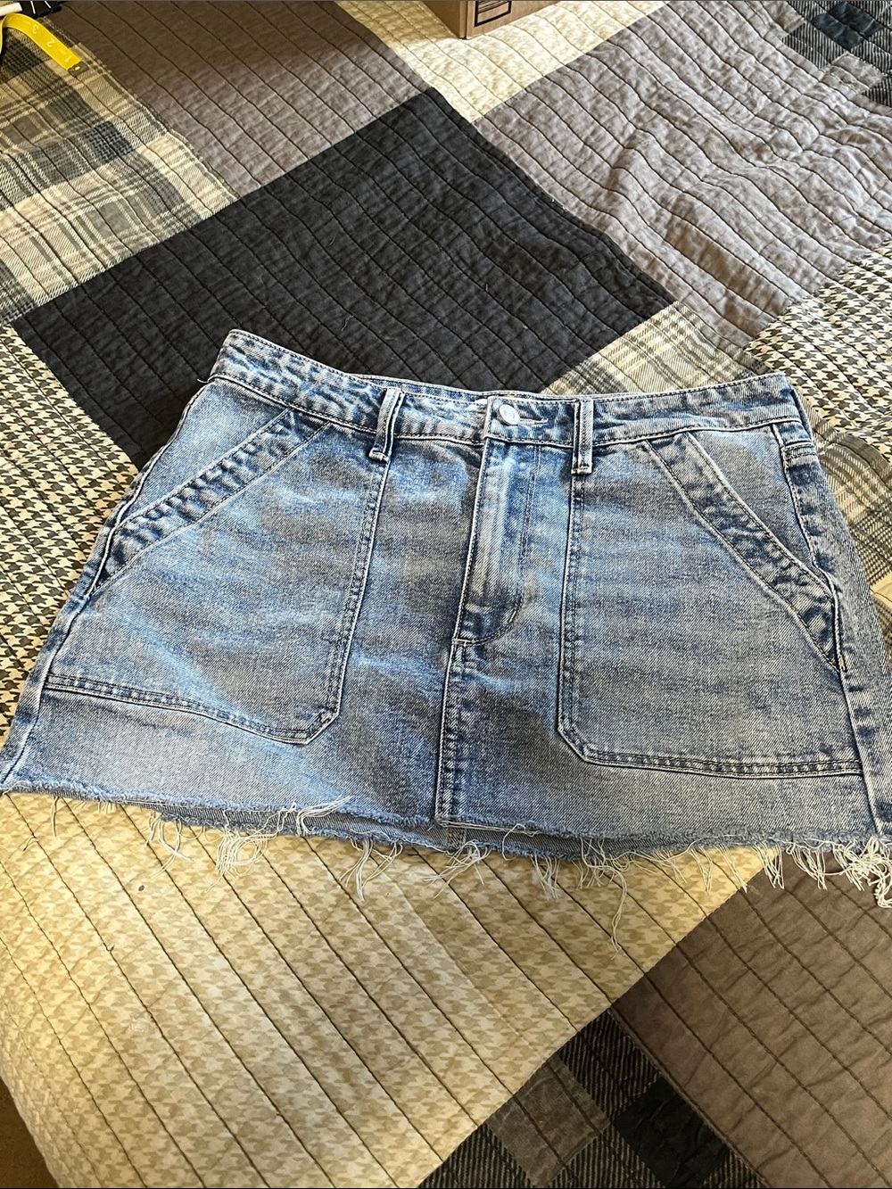 edited by Reno Bader. Size 8. Light Wash Denim Mini Skirt with Front Pockets
